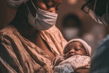 black-mother-who-has-just-given-birth-holding-her-